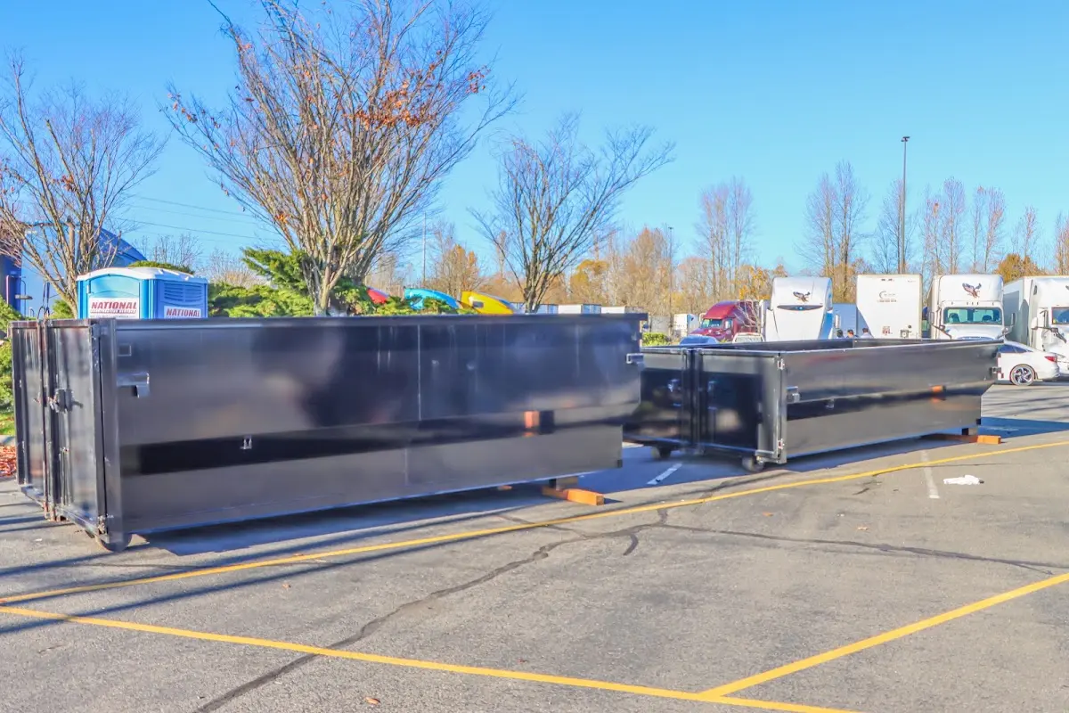 Professional dumpster rental service with roll-off container on residential driveway in Mason City